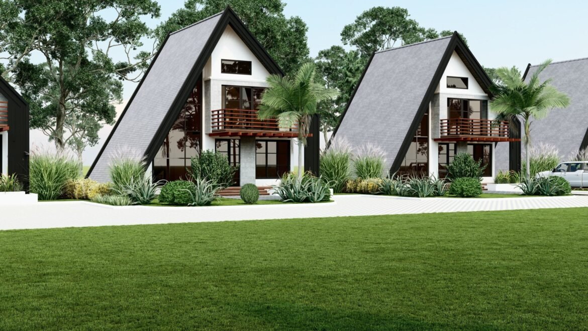 Two A-frame houses with lush greenery and a scenic view.