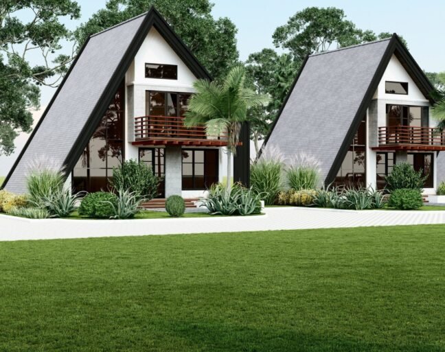 Two A-frame houses with lush greenery and a scenic view.