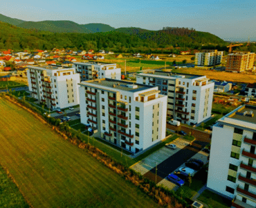 Aerial view of modern apartment buildings in a green landscape.