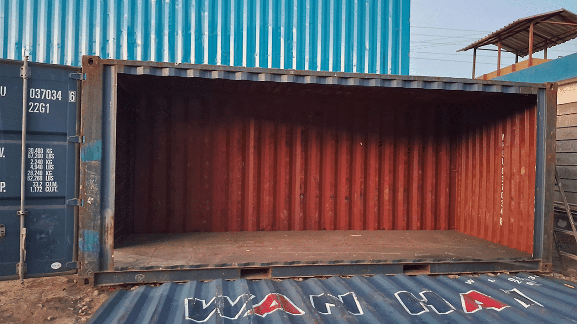 An empty shipping container with red interior and blue exterior.
