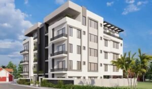 Contemporary multi-story apartment building with greenery around.