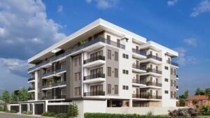 Stylish modern apartment building with balconies and greenery.