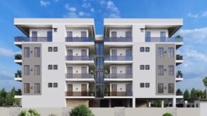 Modern apartment building with balconies and greenery.