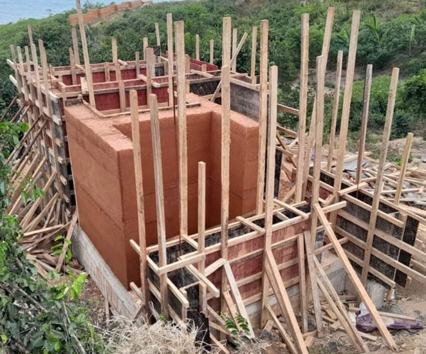 Construction site with wooden supports and building structure.