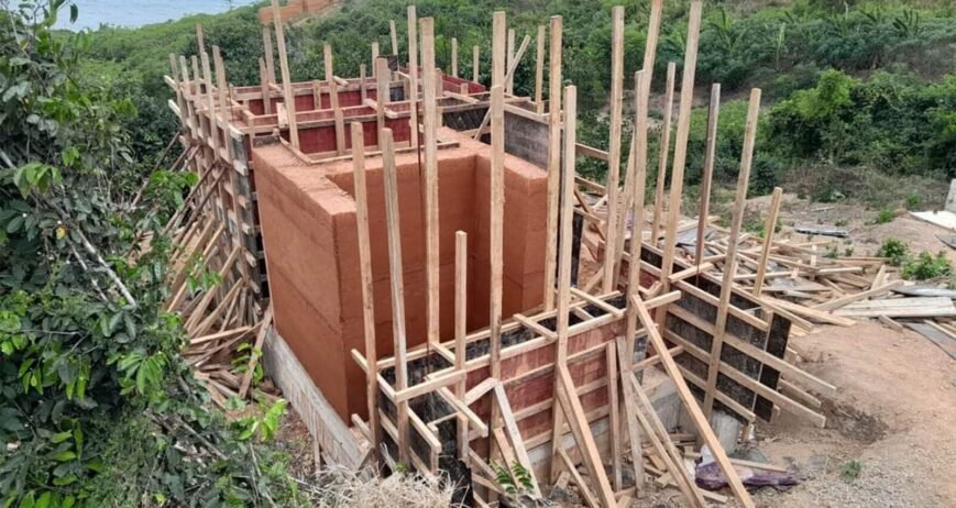 Construction Site With Wooden Supports Construction site with wooden supports and building structure.