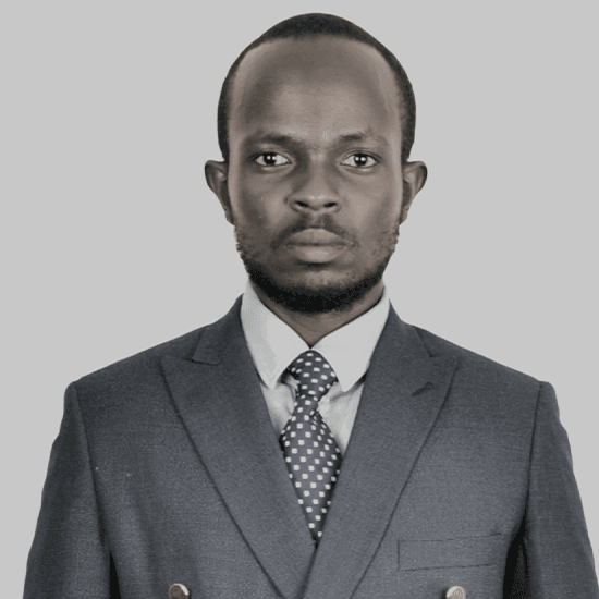 Man in a suit with a serious expression on grey background.