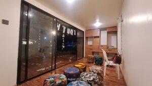 Interior with colorful stools and large glass sliding door.