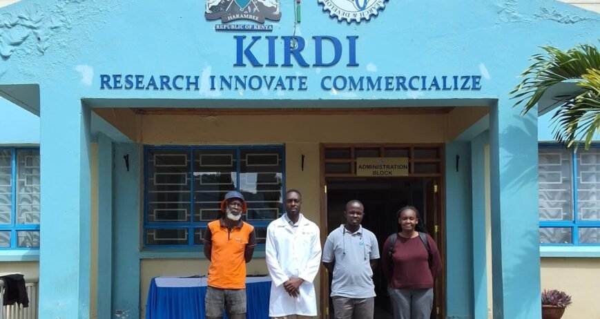 Kiradi Research Innovate Commercialize Four individuals standing before the KIRDI administration building.