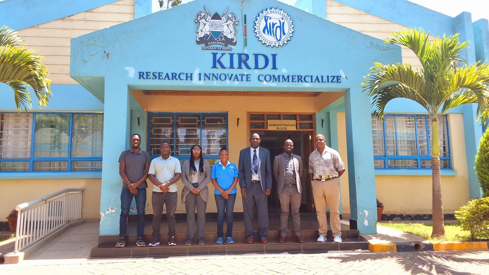 Group of individuals in front of KIRDI building in Kenya.