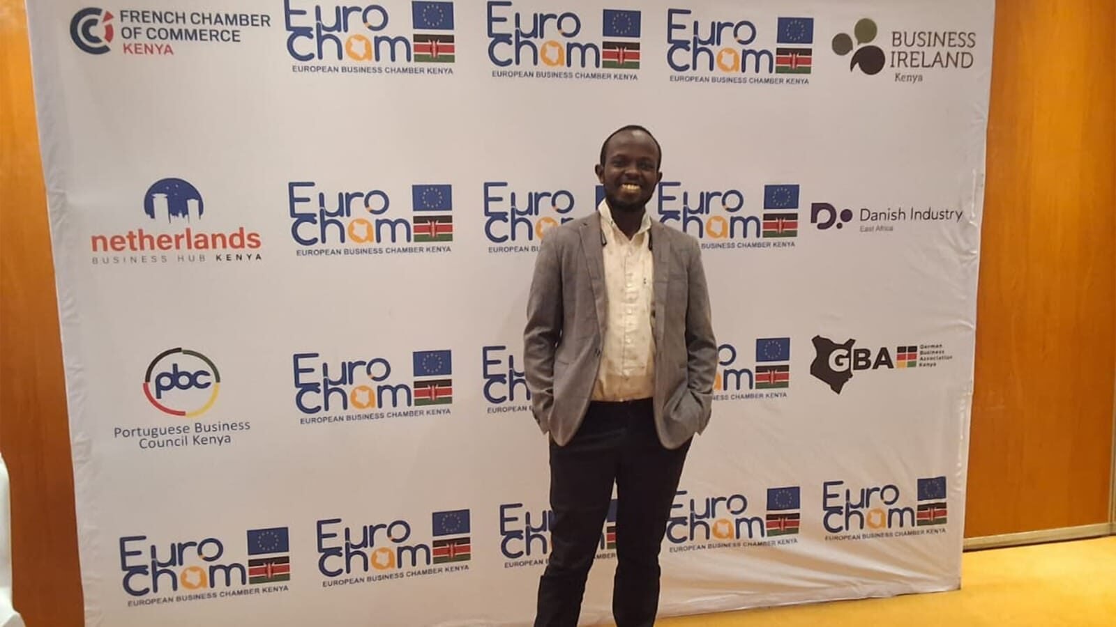 Person standing at EuroCham event backdrop in Kenya.