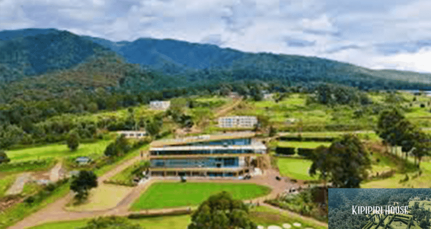 Kipipiri House Aerial view of Kipipiri House surrounded by lush green mountains.