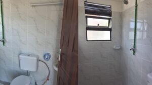 Bright modern bathroom with shower and toilet.