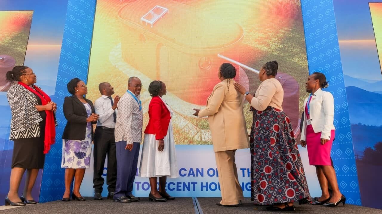 Group of people unveiling a housing initiative presentation.