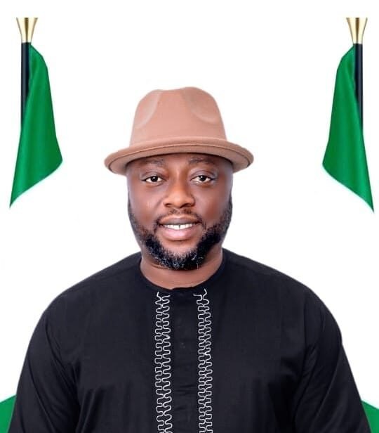 Nigerian Man With Hat Nigerian man in traditional attire with a hat and flags.