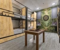 Cozy room with bunk beds, chess table, and dartboard.