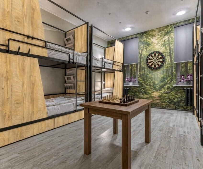 Cozy room with bunk beds, chess table, and dartboard.