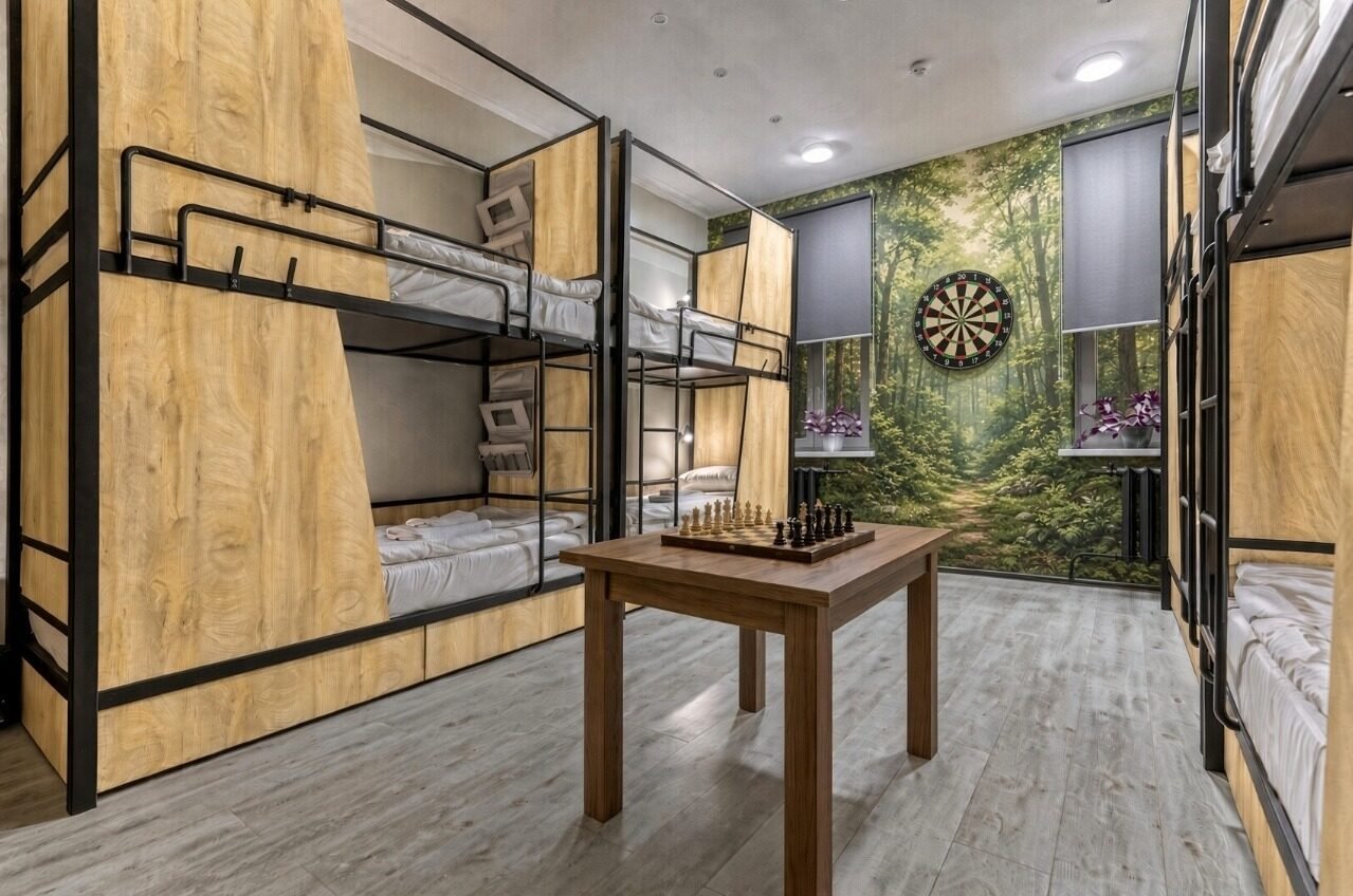 Cozy room with bunk beds, chess table, and dartboard.