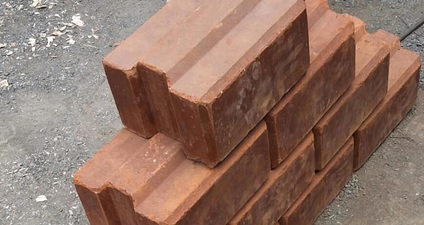 stacked interlocking soil stabilized blocks A stack of interlocking soil stabilized blocks on a gravel surface.